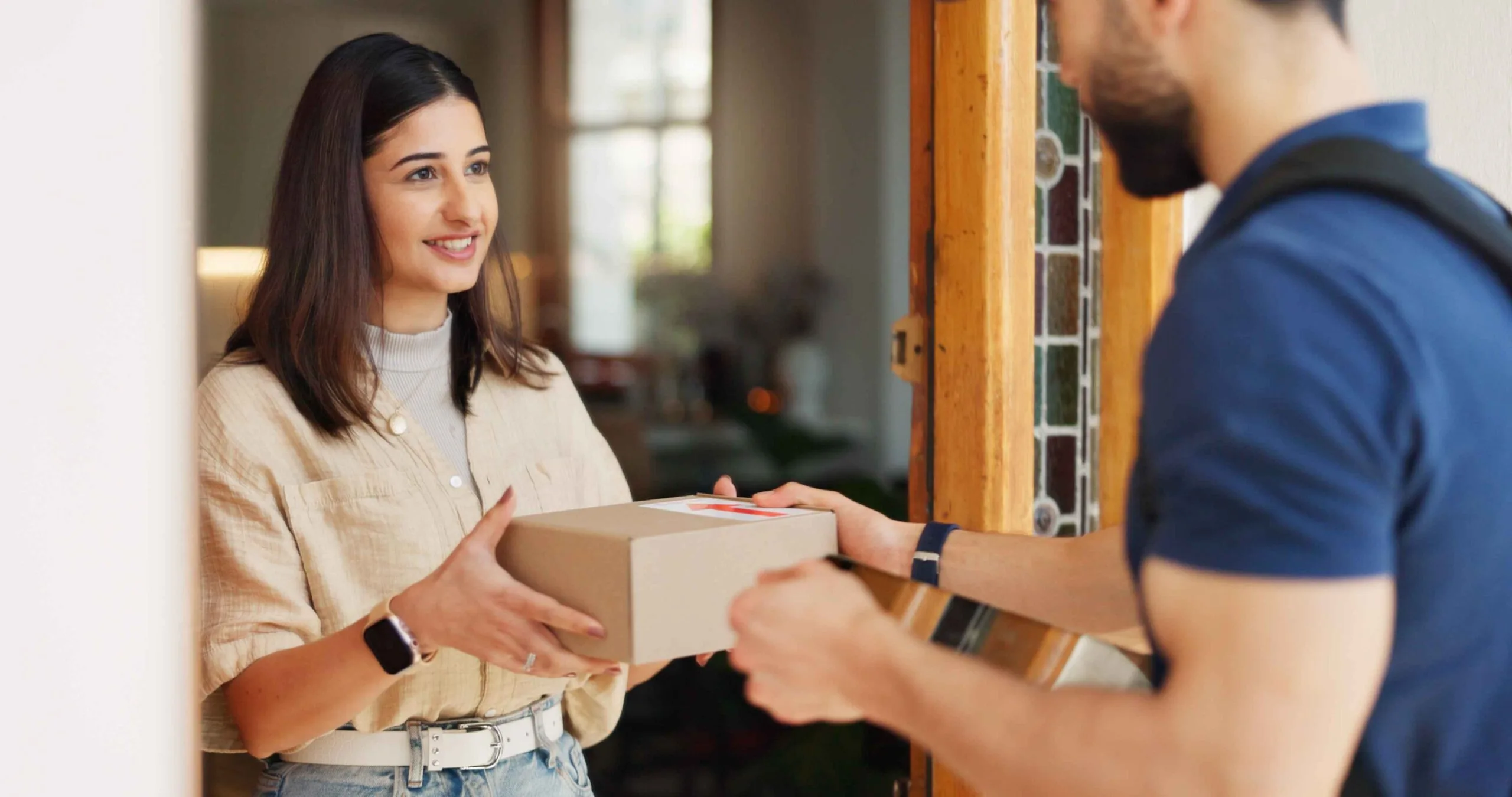 AQUBE Courier driver delivering a parcel to a customer at the door